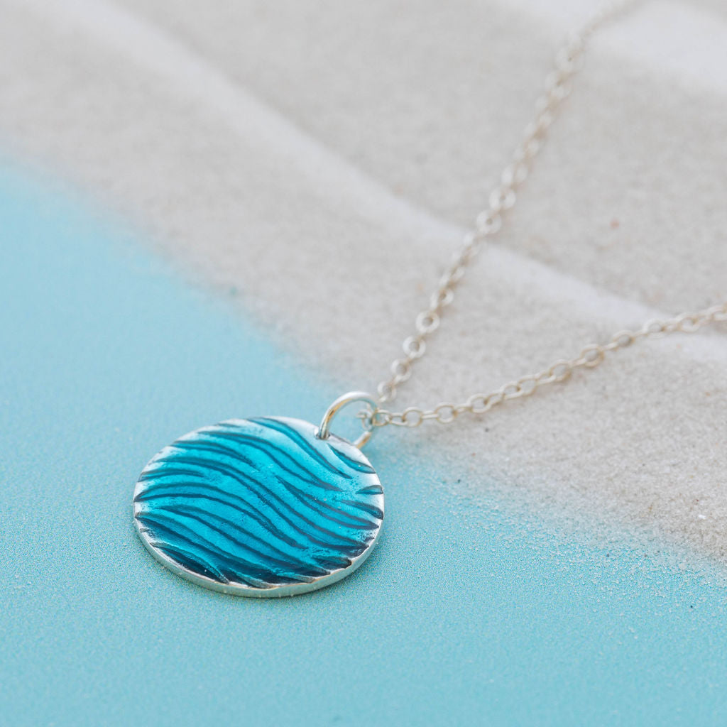 Round silver ripple textured pendant with blue resin overlay by Kate Wimbush Jewellery