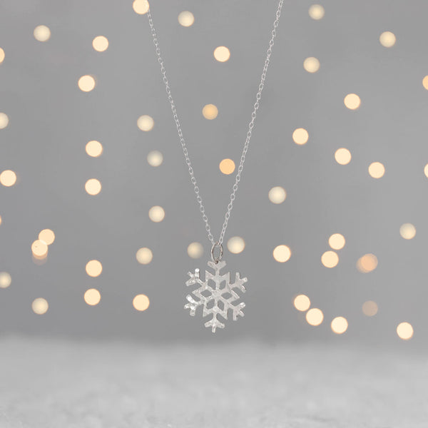 Textured silver snowflake pendant on chain with fairy lights, Kate Wimbush Jewellery