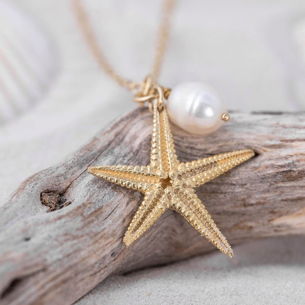 Gold Starfish and white freshwater pearl charm pendant on driftwood by Kate Wimbush Jewellery