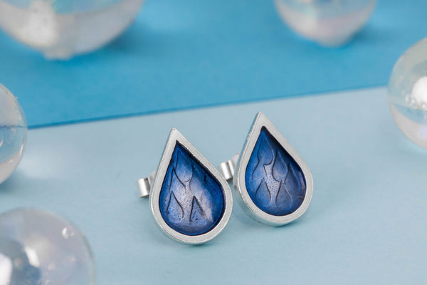 Stamped silver raindrop studs with blue resin and butterfly back, by Kate Wimbush