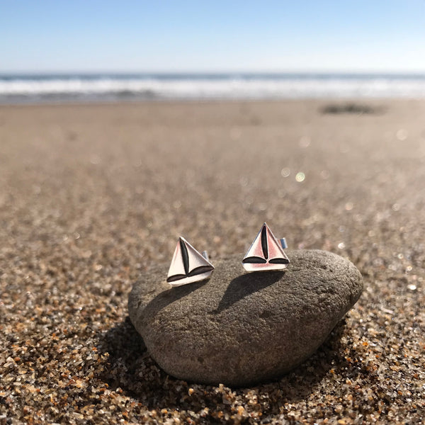 Silver Sail Boat Stud Earrings on Scarborough beach by Kate Wimbush Jewellery