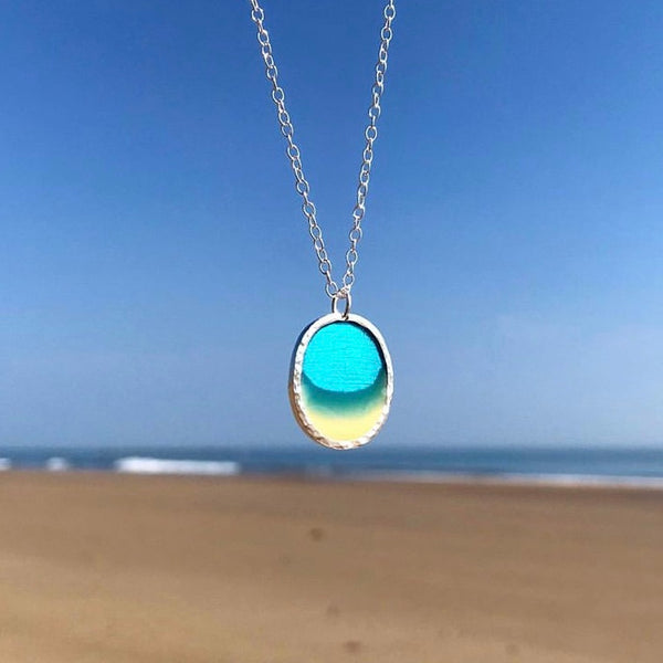 Oval Silver Lagoon Pendant beach scene with textured bezel on Scarborough Beach by Kate Wimbush Jewellery