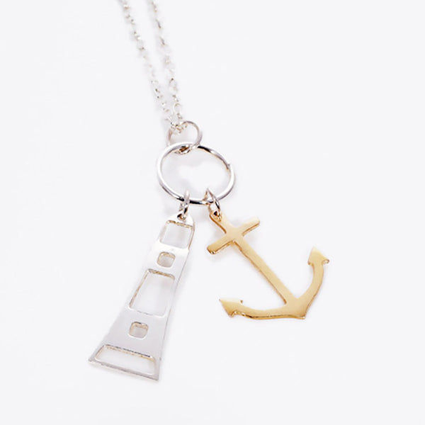 Silver Lighthouse and Gold Anchor Charm Pendant Necklace on white background, Kate Wimbush Jewellery