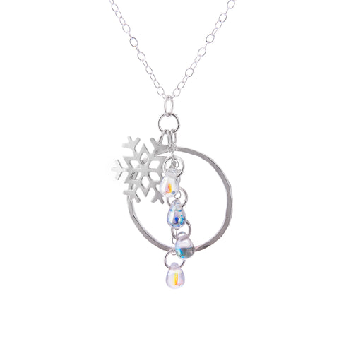 Silver Snowflake Circle Charm Pendant with glass snowdrop beads on white background by Kate Wimbush Jewellery