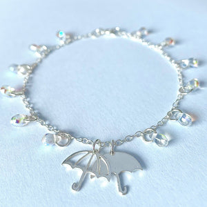 Silver bracelet with two umbrella charms and glass raindrop beads by Kate Wimbush Jewellery